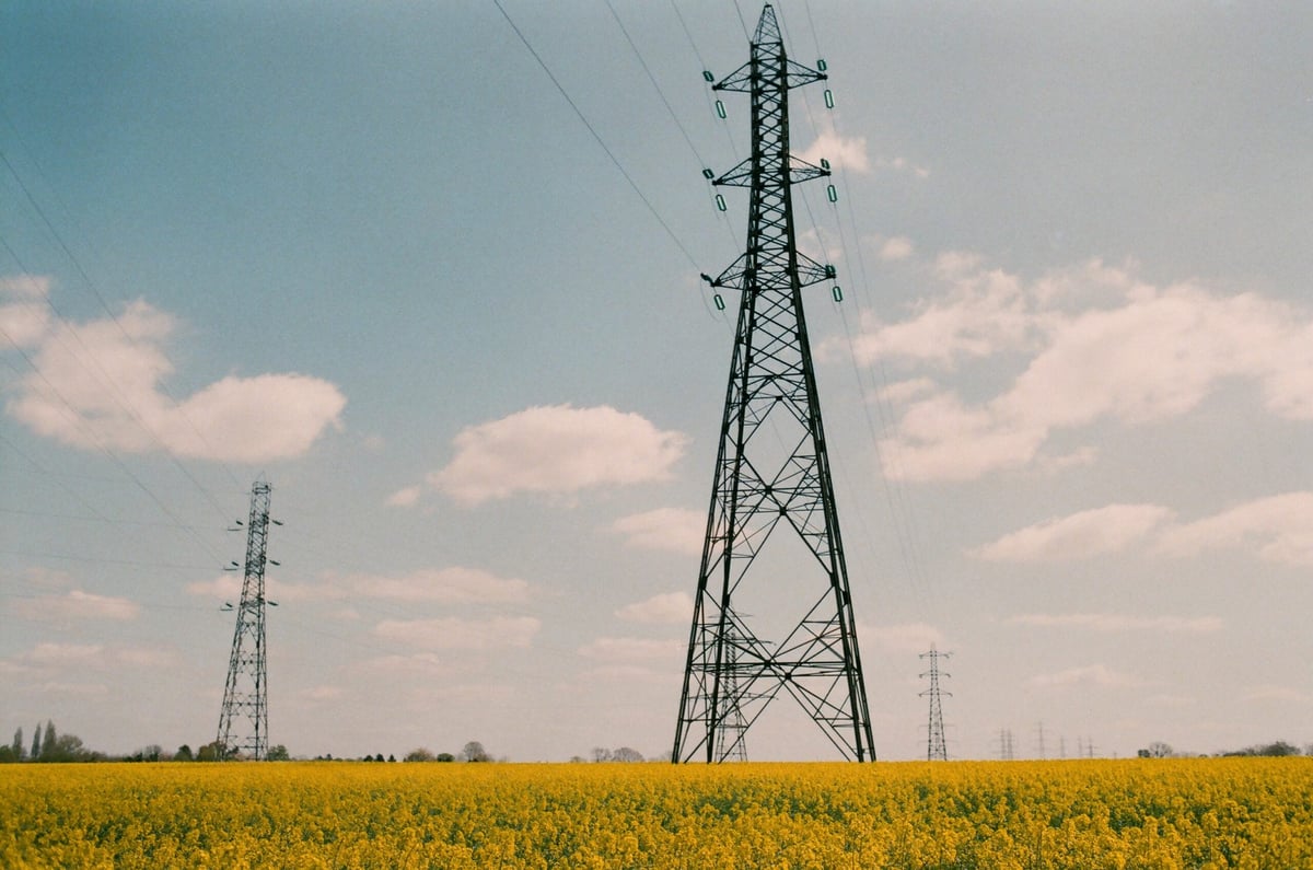 Pylônes et lignes à haute tension traversant un champ en France